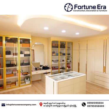 Elegant walk-in closet with gold-trimmed glass cabinets and a central display island.