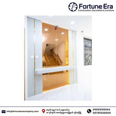 Modern interior with gold mirrored wall and white marble floor.