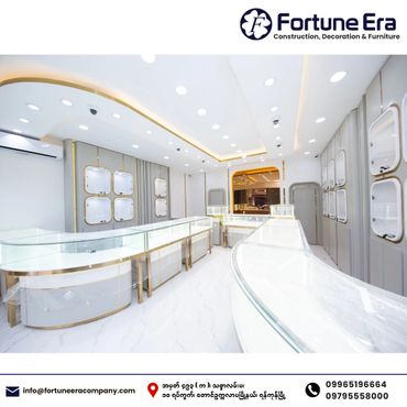 Modern, bright jewelry store interior with sleek glass display counters and elegant lighting.