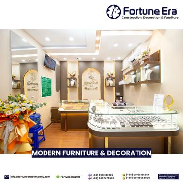 Modern, well-lit jewelry store interior with elegant display cases and floral decorations.