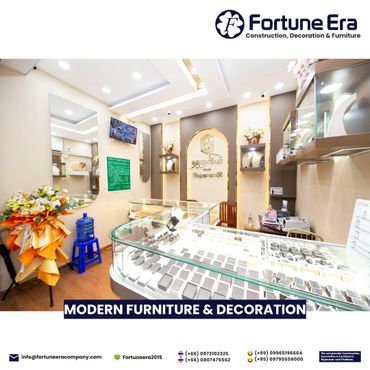 Bright, modern jewelry store interior with glass display cases and floral decorations.