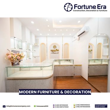 Bright, modern furniture showroom with glass display cases and elegant decor.