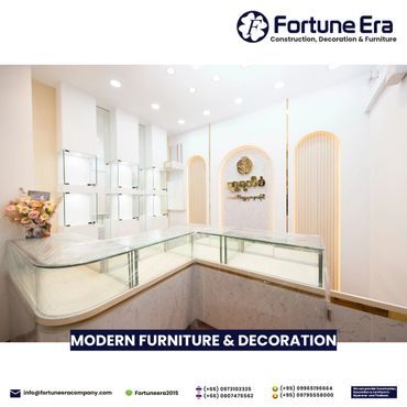 Modern, elegant furniture and decoration showroom with bright lighting and glass display cases.