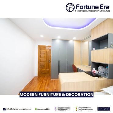 Modern bedroom with sleek furniture and wooden flooring.