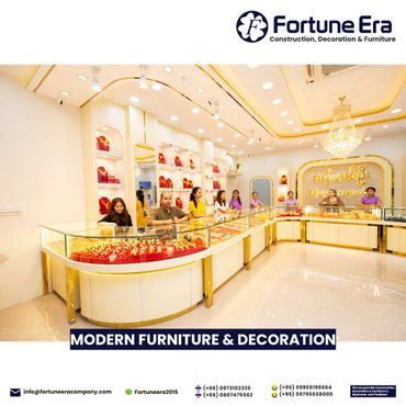 Bright, modern jewelry store interior with glass display cases and staff standing behind counters.