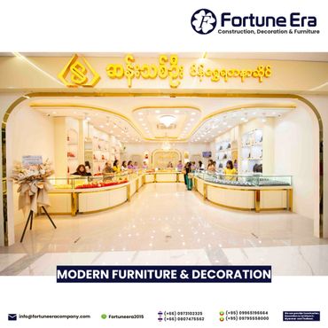 Modern jewelry store interior with bright lighting and golden accents.