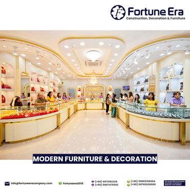 Elegant jewelry store interior with modern gold and glass display counters and bright lighting.