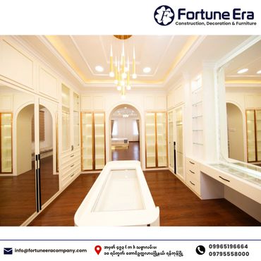 Luxurious walk-in closet with elegant lighting and ample storage space.