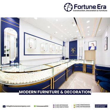 Elegant jewelry store interior with modern blue and gold display counters.