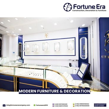 Modern jewelry store interior with elegant blue and gold display cases.
