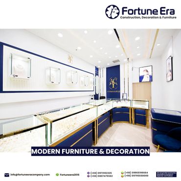 Modern jewelry store interior with elegant blue and gold display cases.