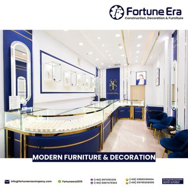 Elegant jewelry store interior with modern blue and gold furniture.