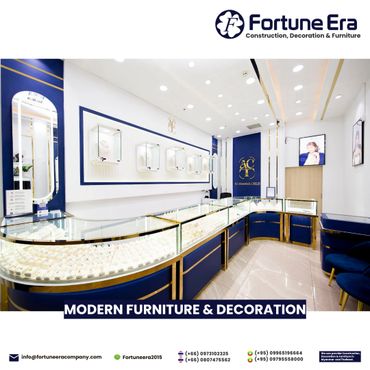 Modern jewelry display counters with blue and gold accents in a sleek showroom.