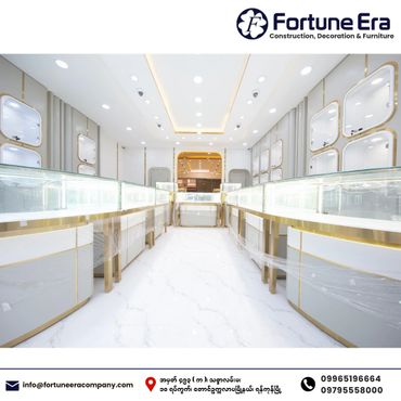 Bright, modern jewelry display counters with gold accents in a pristine showroom.