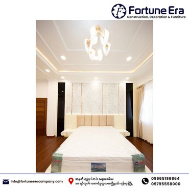 Modern bedroom with elegant ceiling and cozy bed setup.