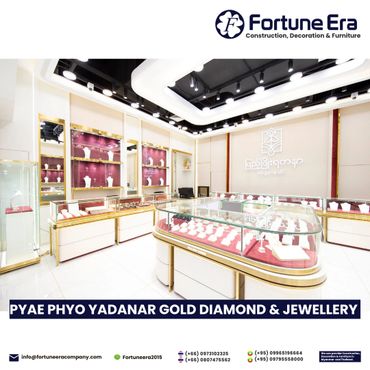 Luxurious jewelry showroom with elegant gold and glass display cases.