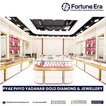 Bright, elegant jewelry store interior with gold accents and glass display cases.