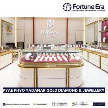 Elegant jewelry showroom with glass displays and gold accents.