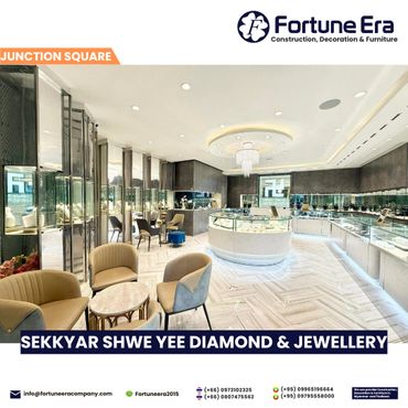Luxurious jewelry store interior with elegant seating and bright display cases.