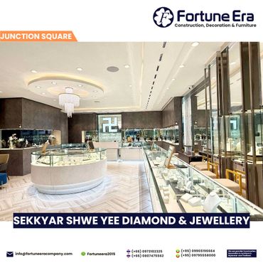 Modern, elegant jewelry store interior with glass displays and chandelier lighting.
