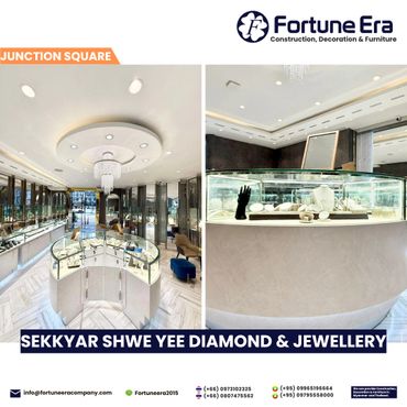 Elegant jewelry store interior with modern display cases and chandelier lighting.