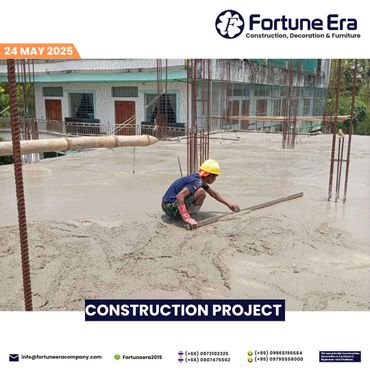 Worker smoothing concrete on a construction site with safety gear.