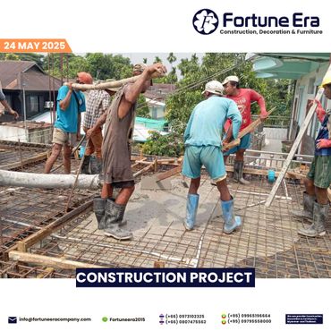 Construction workers actively pouring cement on a building site.