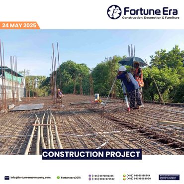 Construction workers surveying a building site with rebar framework under a clear sky.