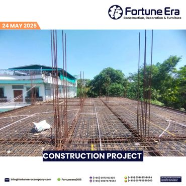 Steel reinforcement framework for a building under construction on a clear day.