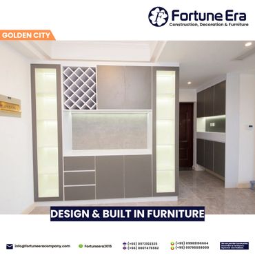 Modern built-in furniture with illuminated shelves and wine rack in a sleek living space.