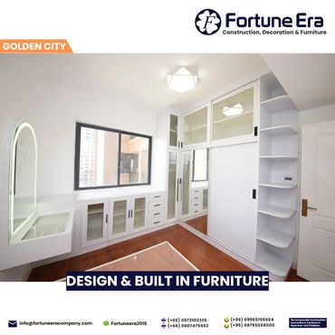 Modern white built-in furniture in a bright room with wooden flooring.