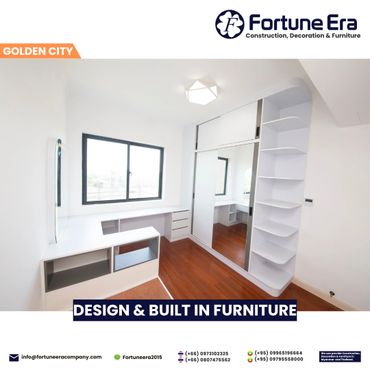 Modern white furniture with built-in shelves and a large mirror in a bright room.