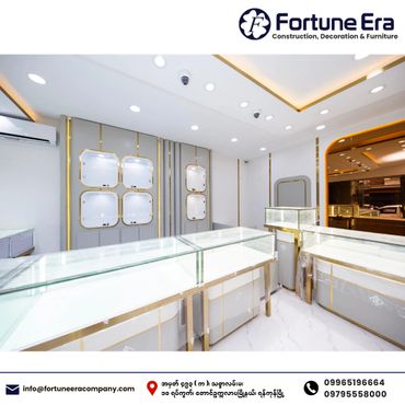 Modern, elegant jewelry display counters in a bright showroom with gold accents.