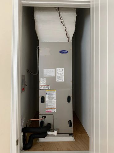 Carrier HVAC unit installed in a closet.