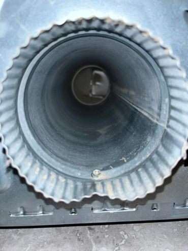 Close-up of a metal vent pipe interior.