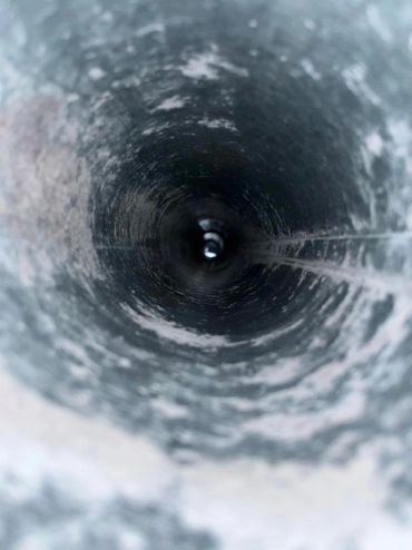 A view down a textured cylindrical pipe.