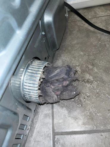 Dryer vent clogged with lint.
