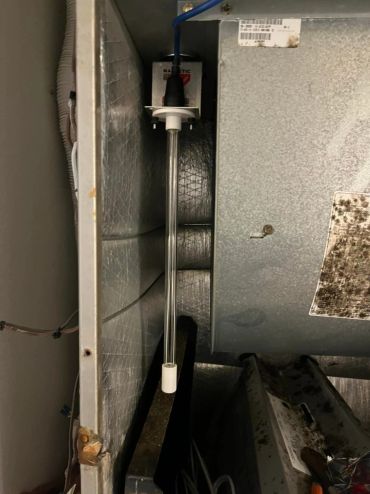 Heating or HVAC unit component inside a metal enclosure.
