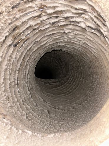 Dust and debris buildup inside a duct.