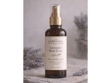 Bottle of Lavender Sleep Spray with a gold spray cap on a soft background.