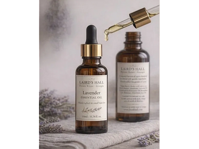 Brown glass bottles of Laird's Hall lavender essential oil with a dropper.