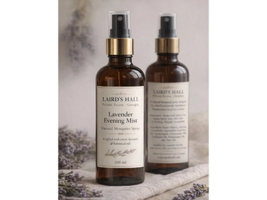 Two amber bottles of Laird's Hall Lavender Evening Mist mosquito spray with sprayers.