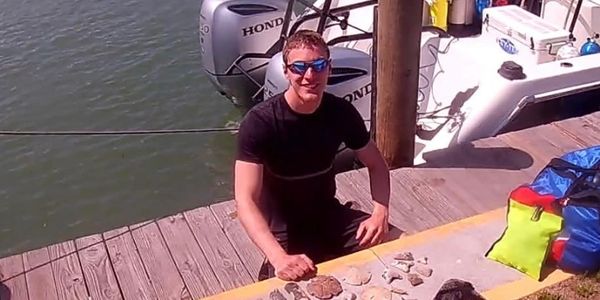 Owner and Instructor Trainer Justin Bowers after a fossil dive finding several megalodon teeth