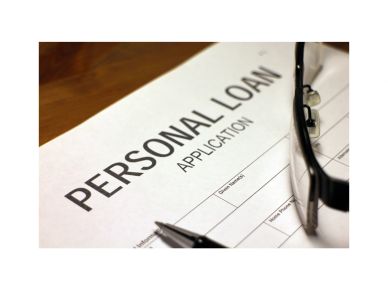 Personal loan application form with glasses and pen.