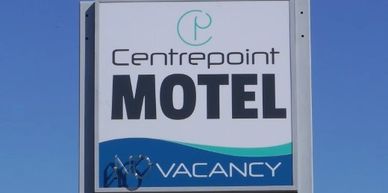 Illuminated pylon sign for Centrepoint Motel, Deniliquin. Vinyl lettering on perspex & aluminium.