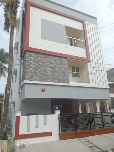 Modern three-story house with a mix of stone and painted exterior walls.