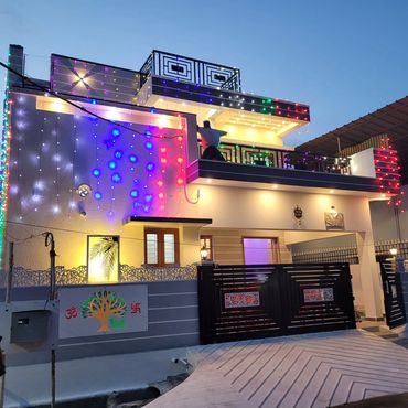 Modern house decorated with colorful lights at dusk.