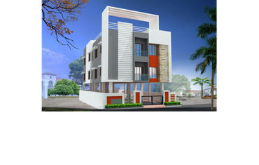 Modern three-story building with white, grey, and orange accents under a clear blue sky.