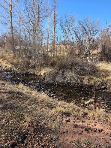 The river runs along the west side of the RV park