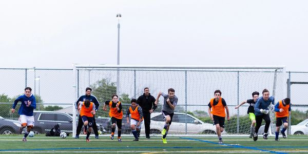 Soccer team running as a team on a soccer field